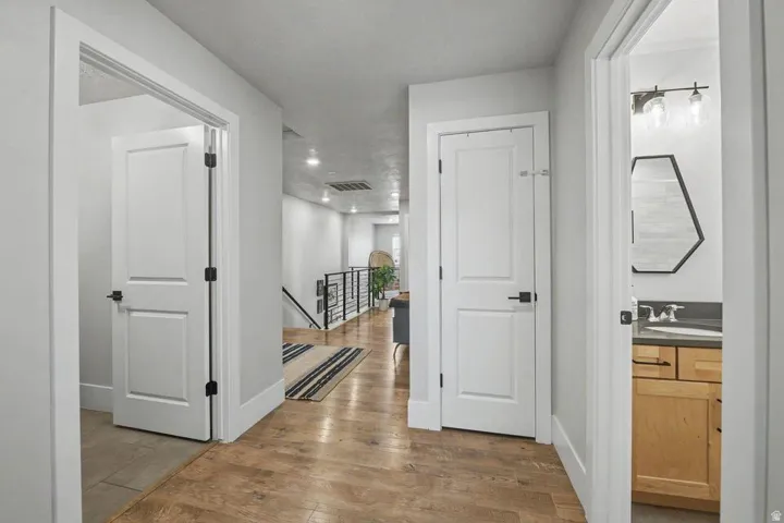 Hallway featuring wood-finish flooring and recessed lighting