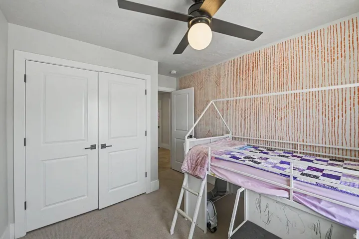 Interior room with soft neutral carpeting and textured wall covering