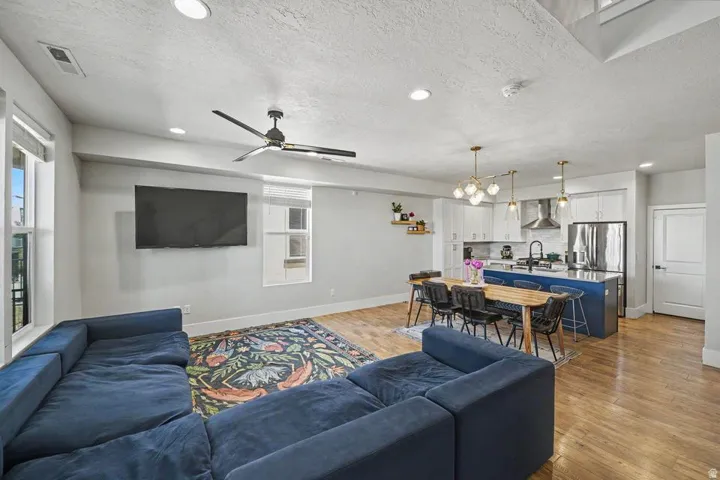 Open-concept living space featuring wood-finish flooring throughout