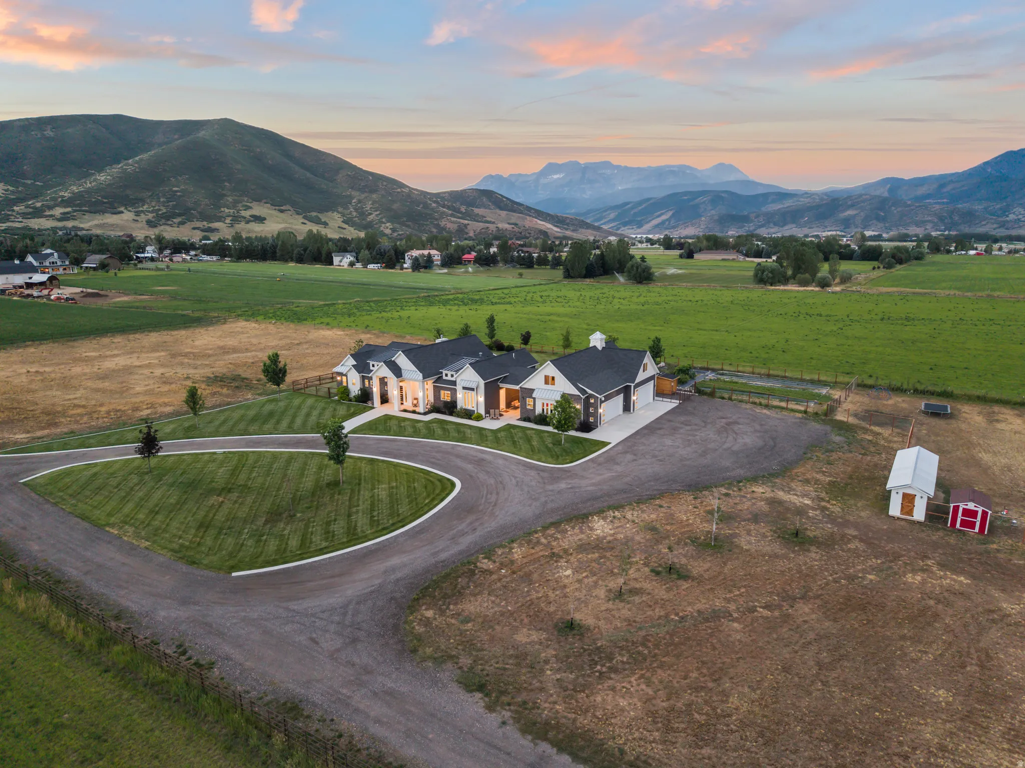 Expansive estate featuring a large main residence, circular drive, and substantial acreage
