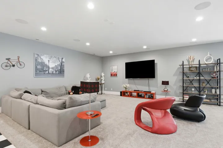 Spacious room featuring light gray walls and plush carpeting