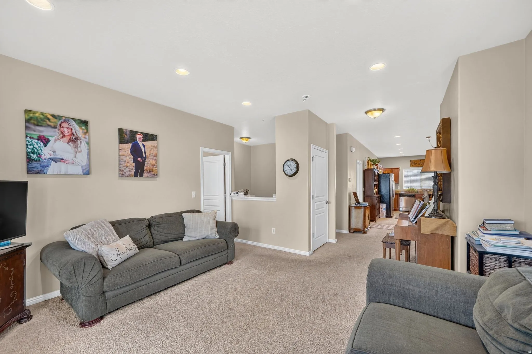 Carpeted living area featuring recessed lighting and neutral wall tones