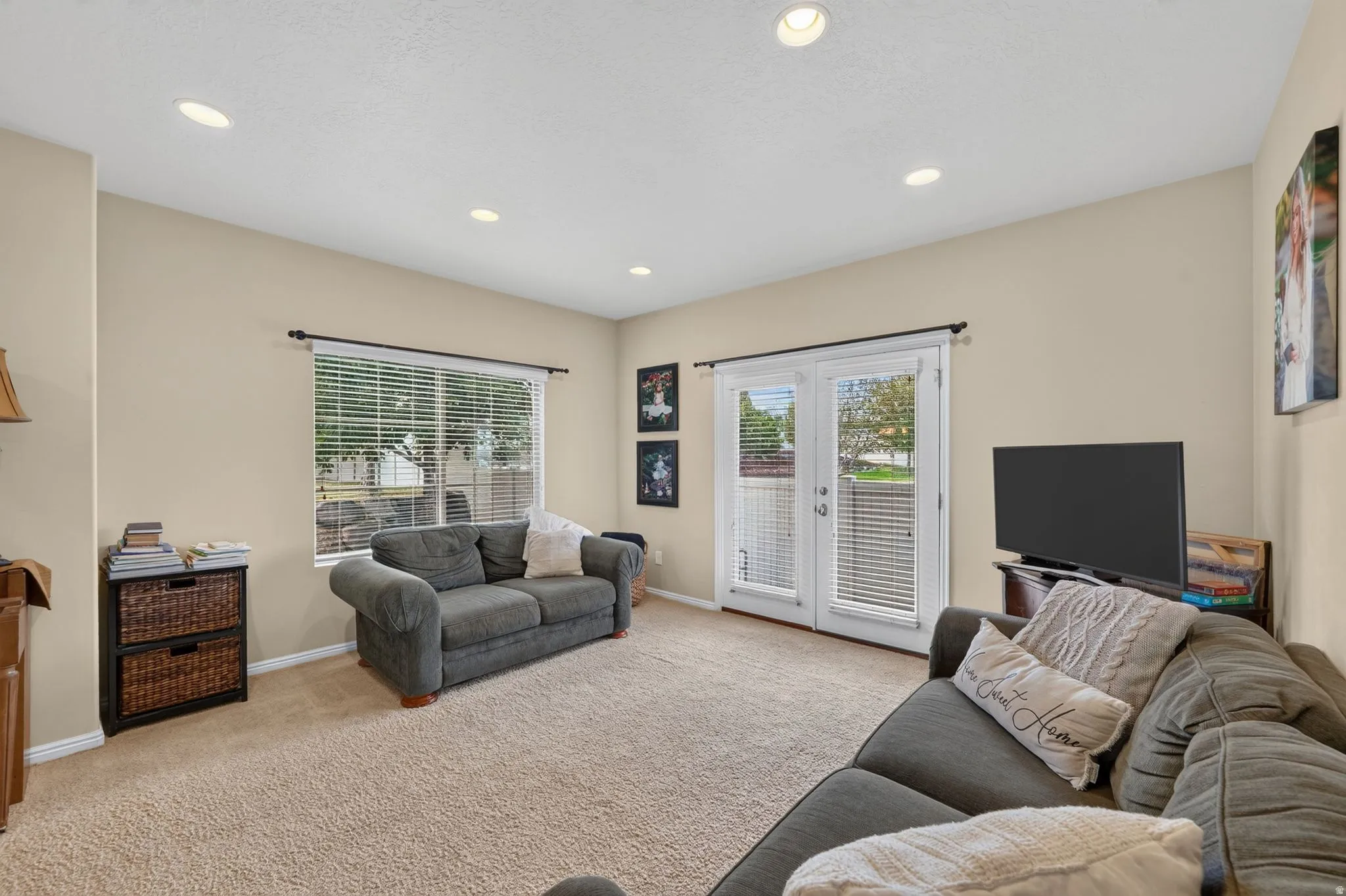 Living area featuring recessed lighting, neutral wall paint, and plush carpet flooring