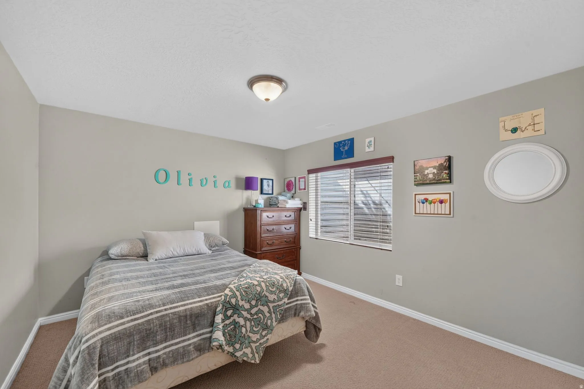 Neutral tone wall paint with white baseboards, a single window with blinds, and a built-in ceiling light fixture