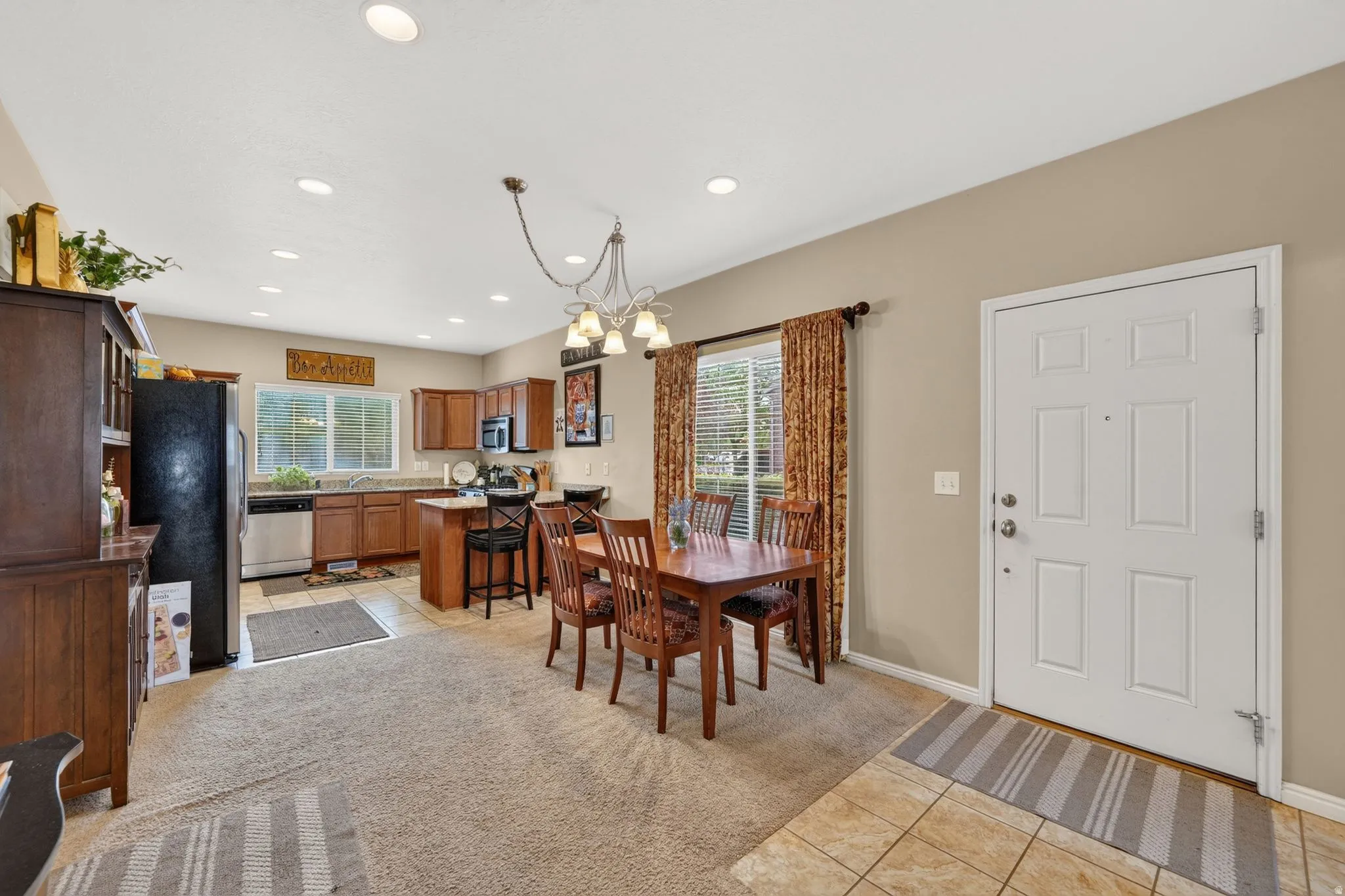 Open-concept living space with a kitchen, dining area, and entryway