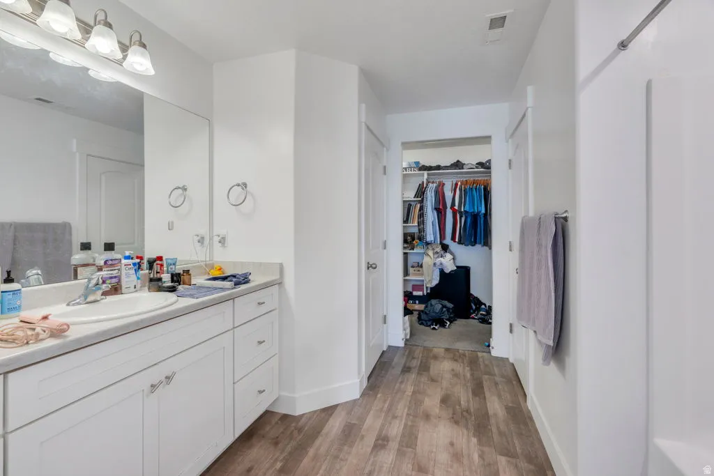 Bathroom with a single vanity featuring a white countertop and white cabinetry