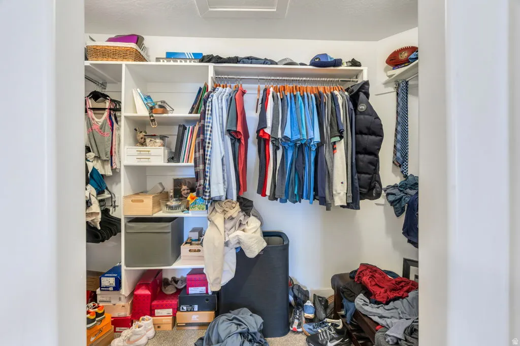 White built-in closet system featuring multiple hanging rods and shelving units