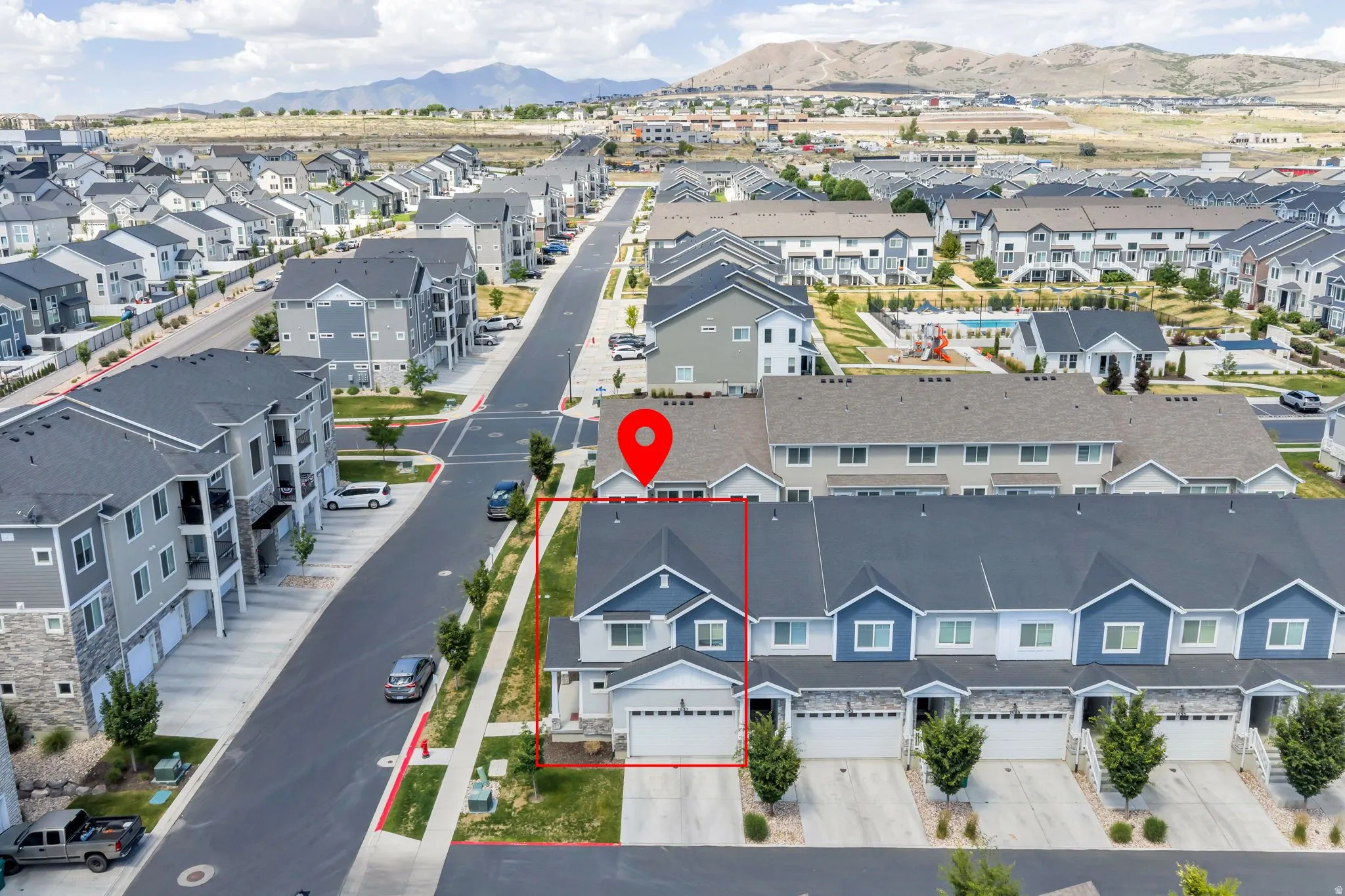 Modern townhome featuring a two-story design, attached garage, and a paved driveway