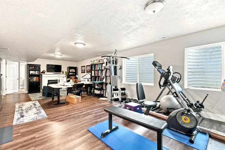 Spacious lower level featuring wood-finish flooring, recessed lighting, and multiple windows