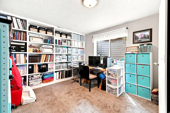 Built-in wall-to-wall shelving provides extensive storage and organization
