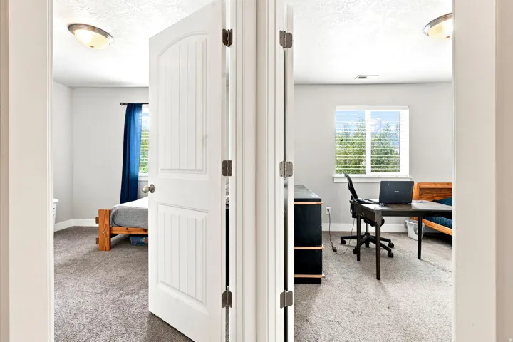 Two rooms featuring light gray wall paint and textured ceilings