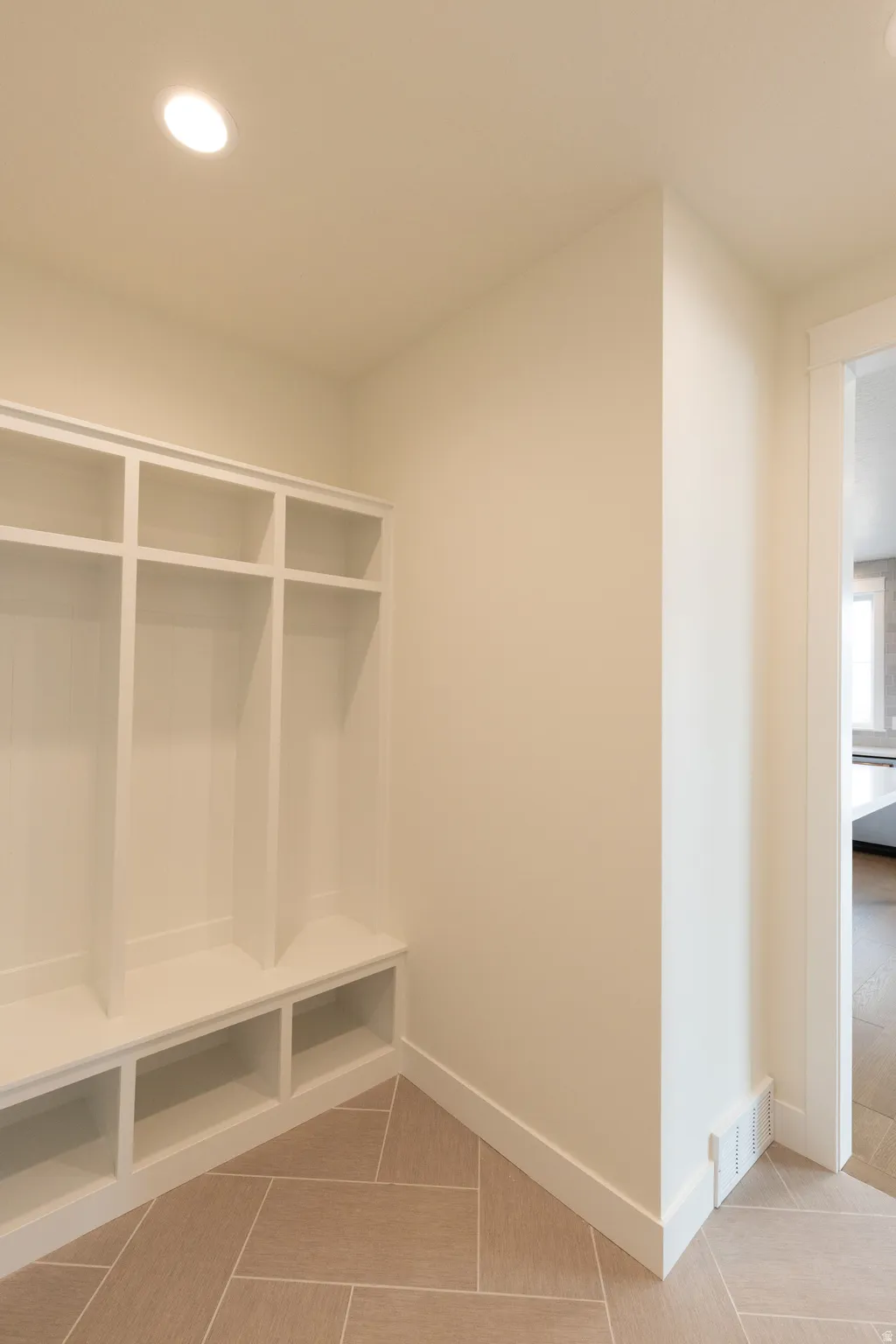 Built-in mudroom storage with open shelving and bench seating