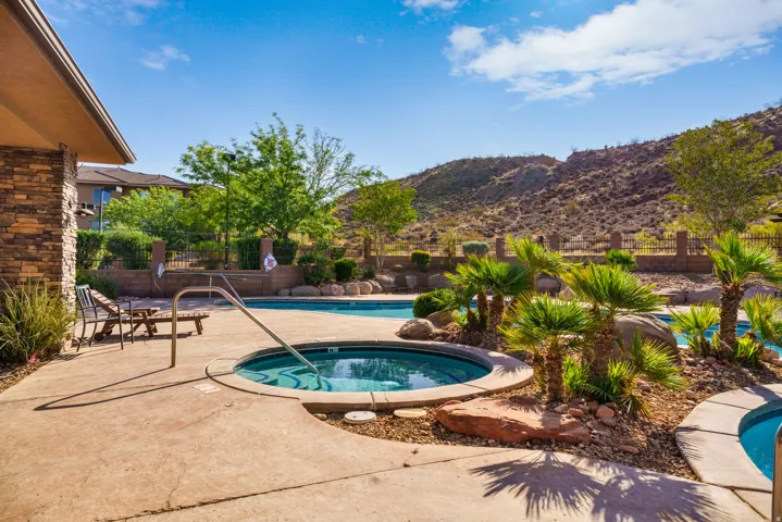 Outdoor spa with integrated handrail and surrounding concrete patio