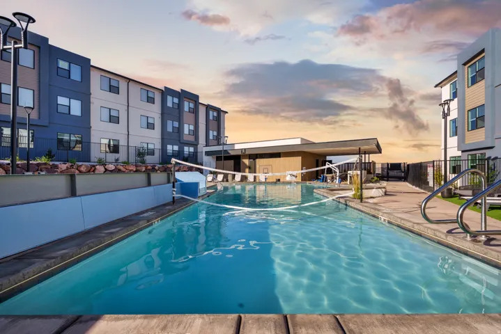 Outdoor swimming pool featuring a volleyball net