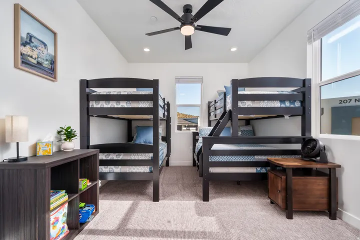 Bright room featuring high vaulted ceilings, recessed lighting, and a contemporary ceiling fan