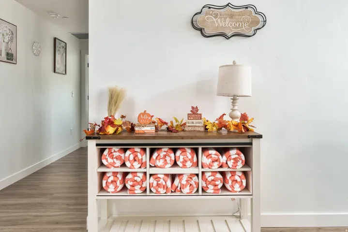 Hallway featuring light wood-finish flooring, white baseboards, and bright white walls