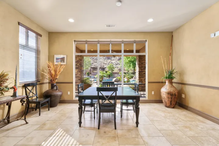 Tile flooring with a neutral finish, featuring a large window with blinds and a sliding glass door