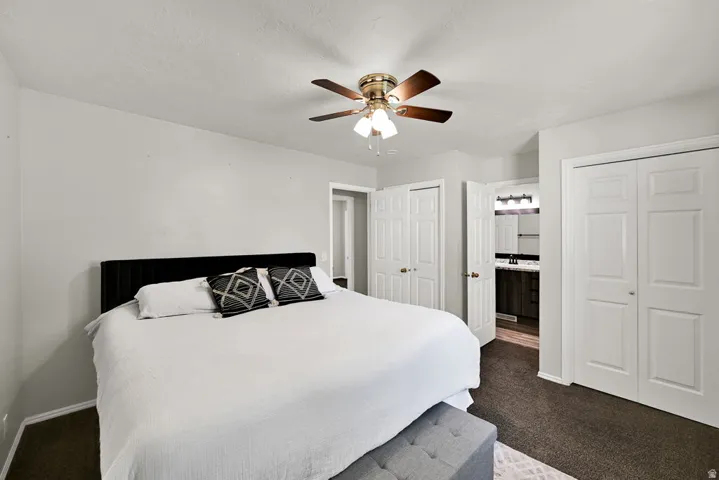 Bedroom featuring plush carpeting and a ceiling fan with integrated lighting