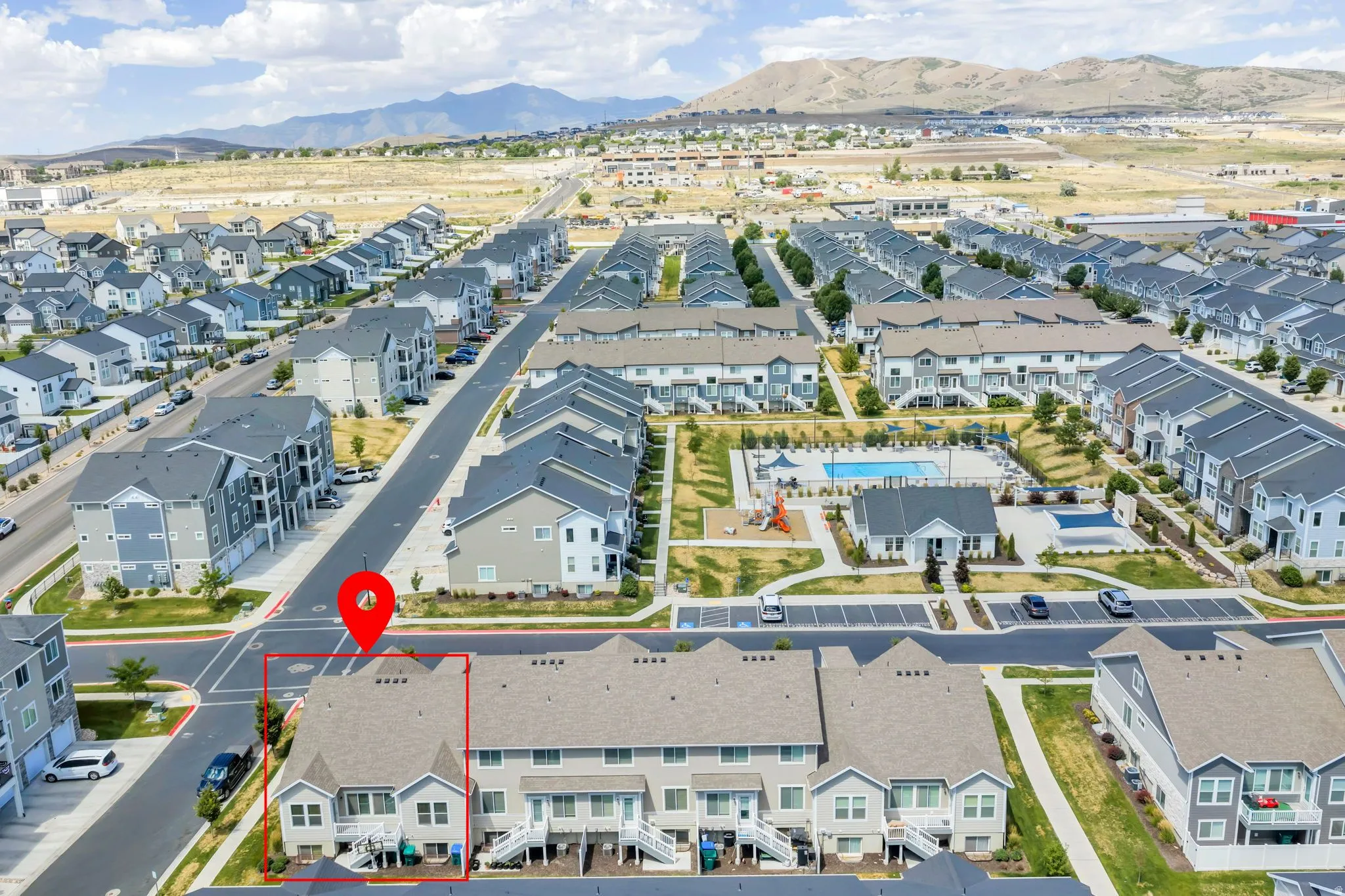 End-unit townhome featuring a multi-level exterior, two private balconies, and a fenced yard