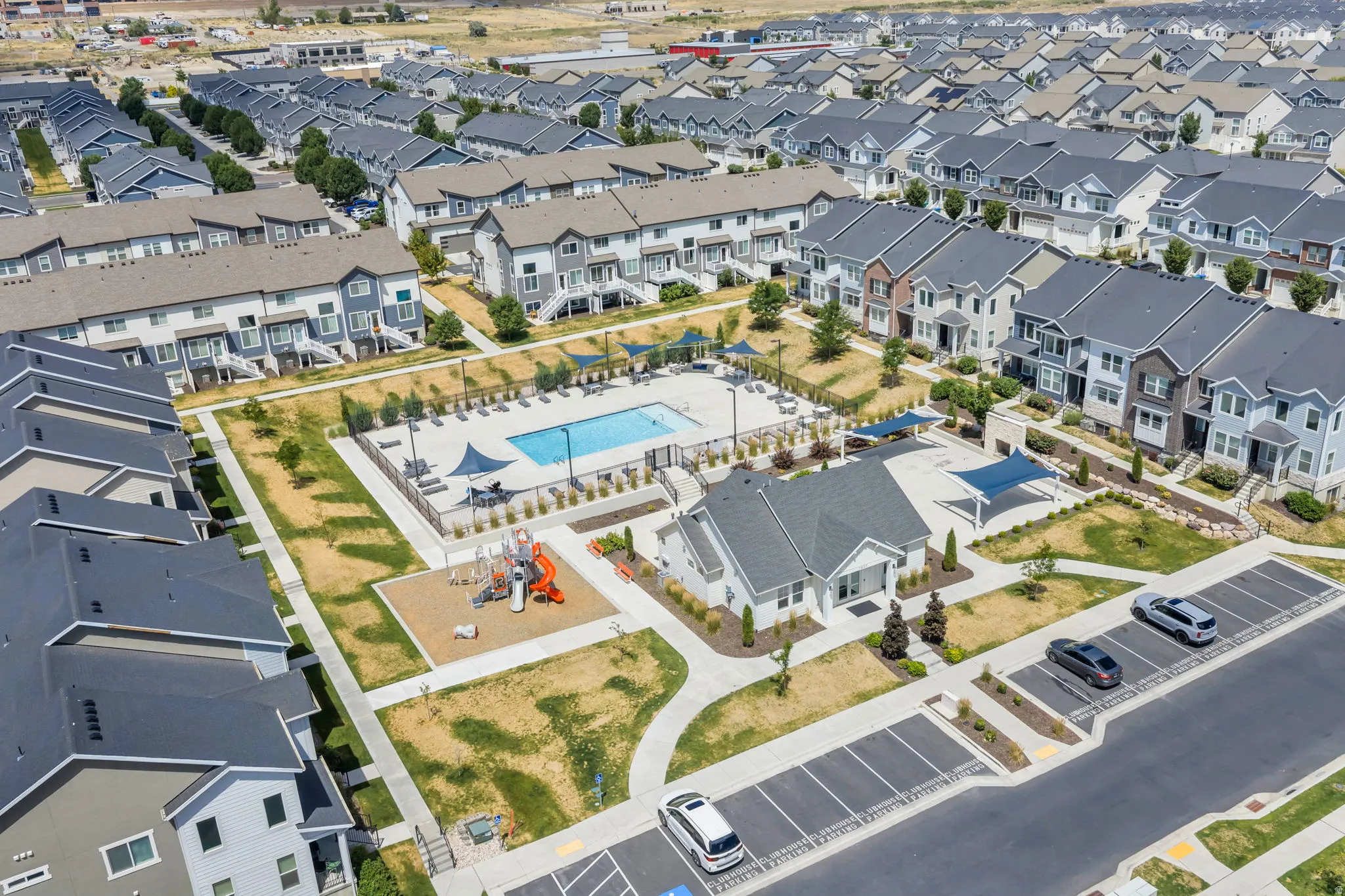 Community hub featuring a swimming pool, clubhouse, and playground