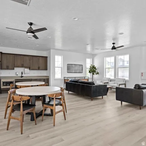 Open-concept living space with light wood-finish flooring