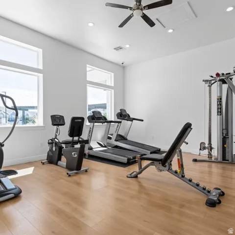 Spacious room featuring wood-finish flooring and multiple windows