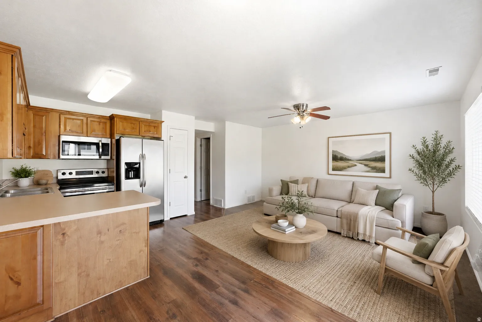 Open-concept living space featuring wood-finish flooring