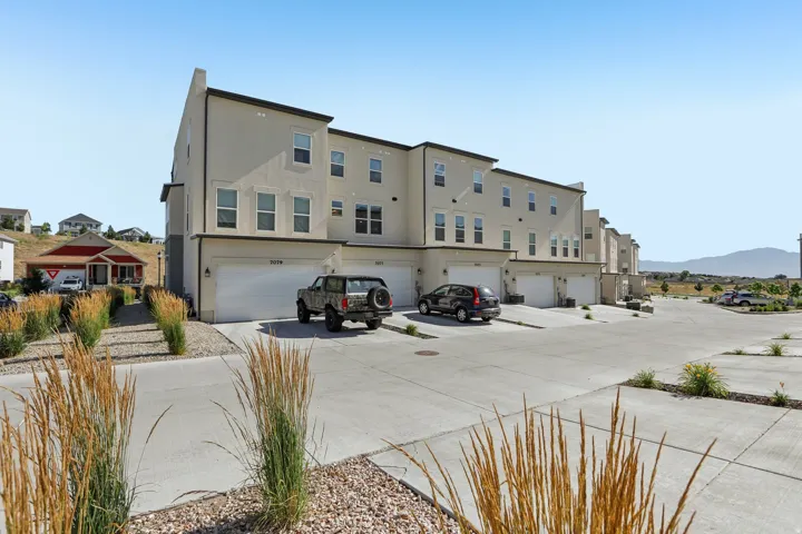 Contemporary townhome exterior featuring light-colored stucco siding