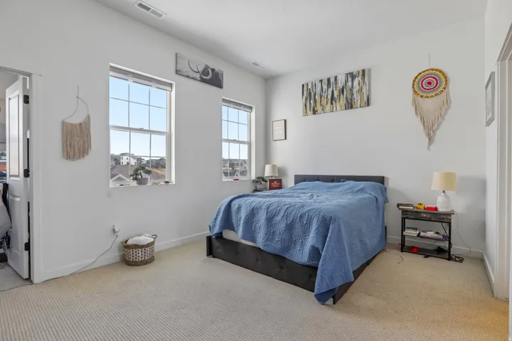 Carpeted room with two double-hung windows, a recessed lighting fixture, and a white paneled door