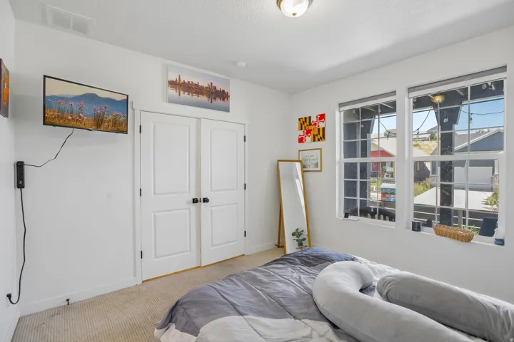 Bright room with two large windows, white trim, and a textured carpet