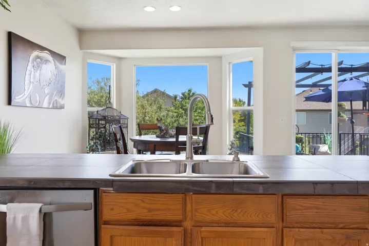 Kitchen island with a double basin stainless steel sink and a gooseneck faucet