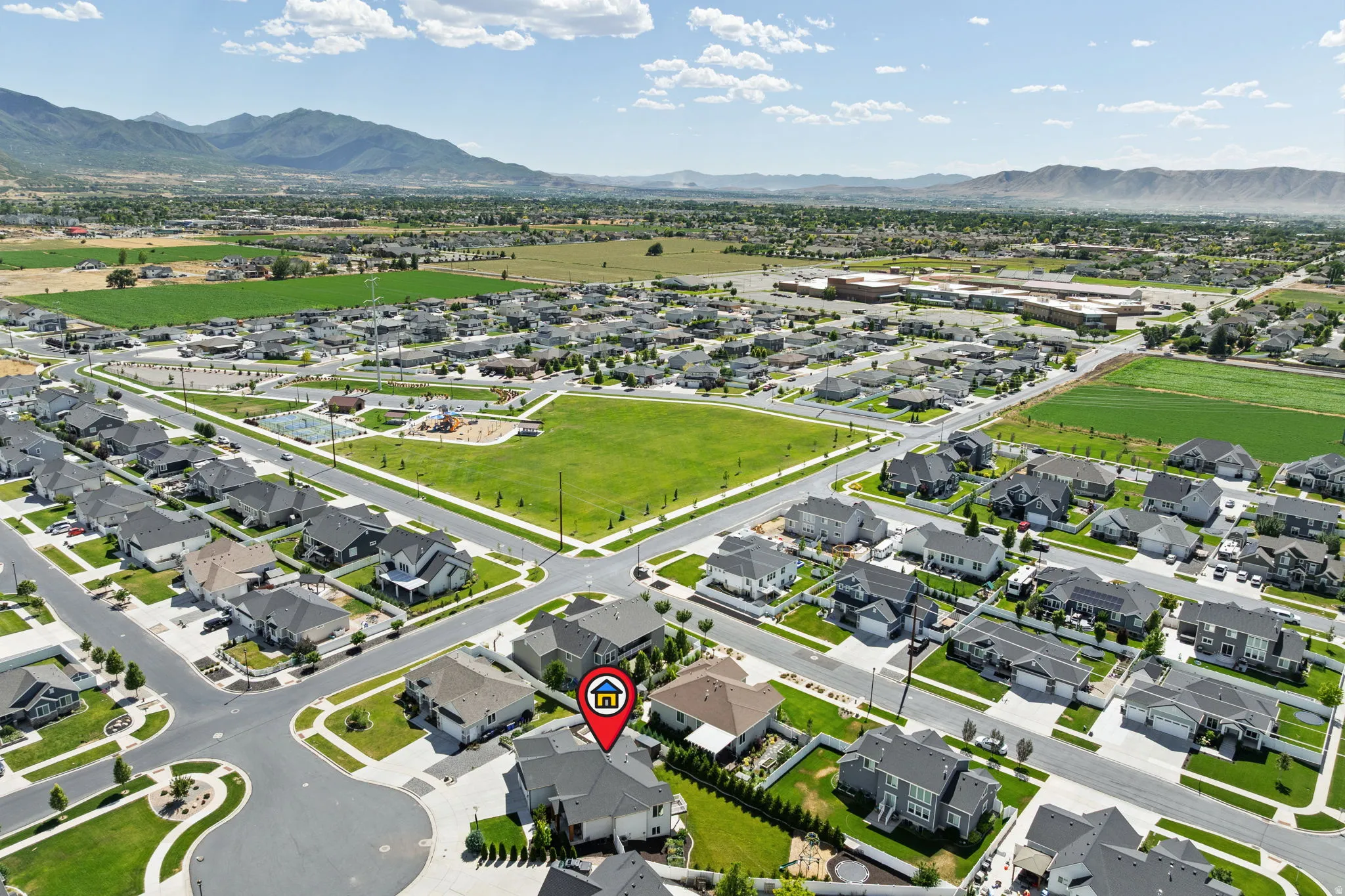 Aerial perspective highlighting a residential community with distant mountain ranges