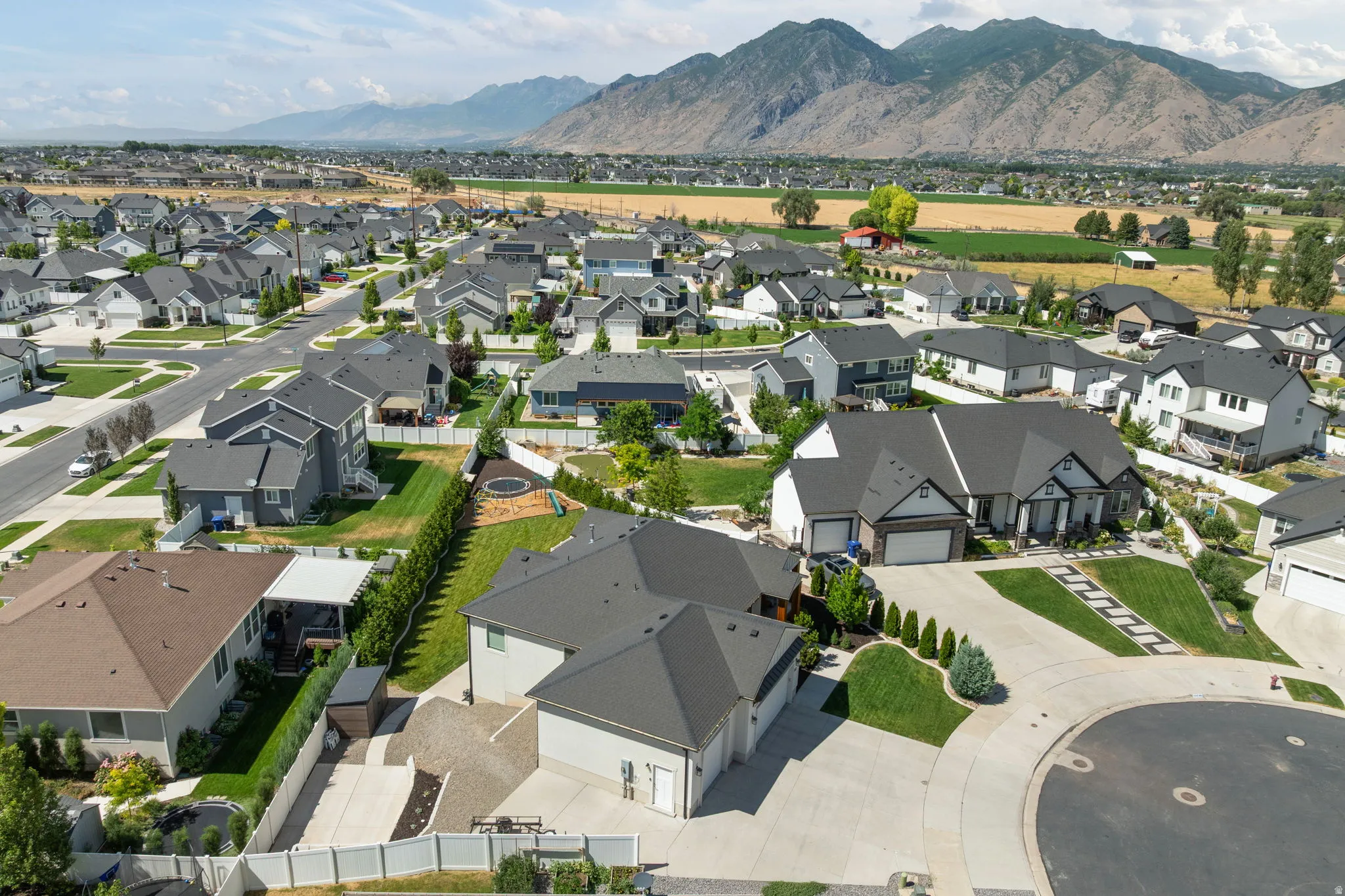 Residential neighborhood featuring various architectural styles, paved streets, and landscaped yards