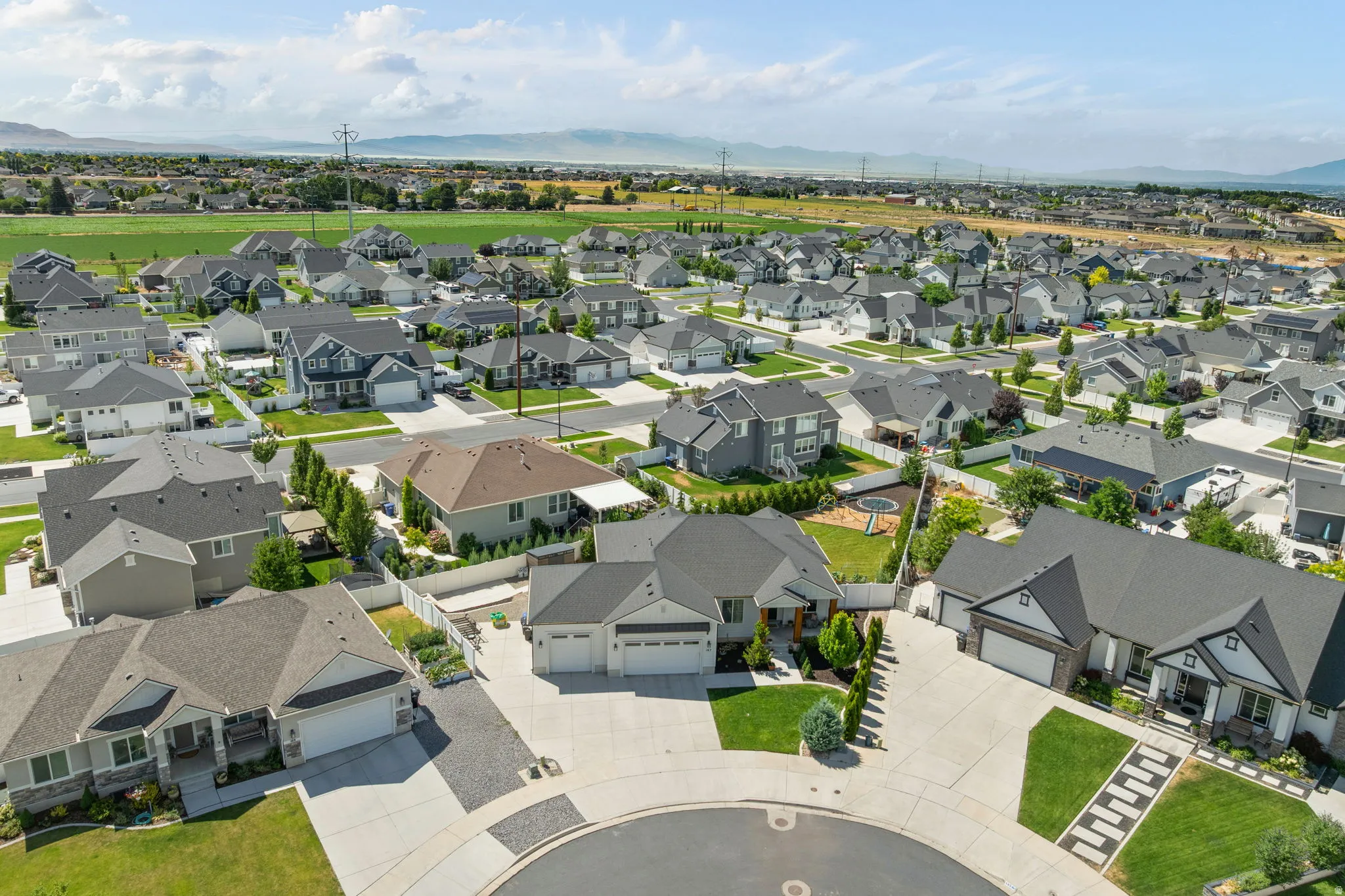 Expansive aerial view showcasing a developed residential neighborhood with a variety of single-family homes