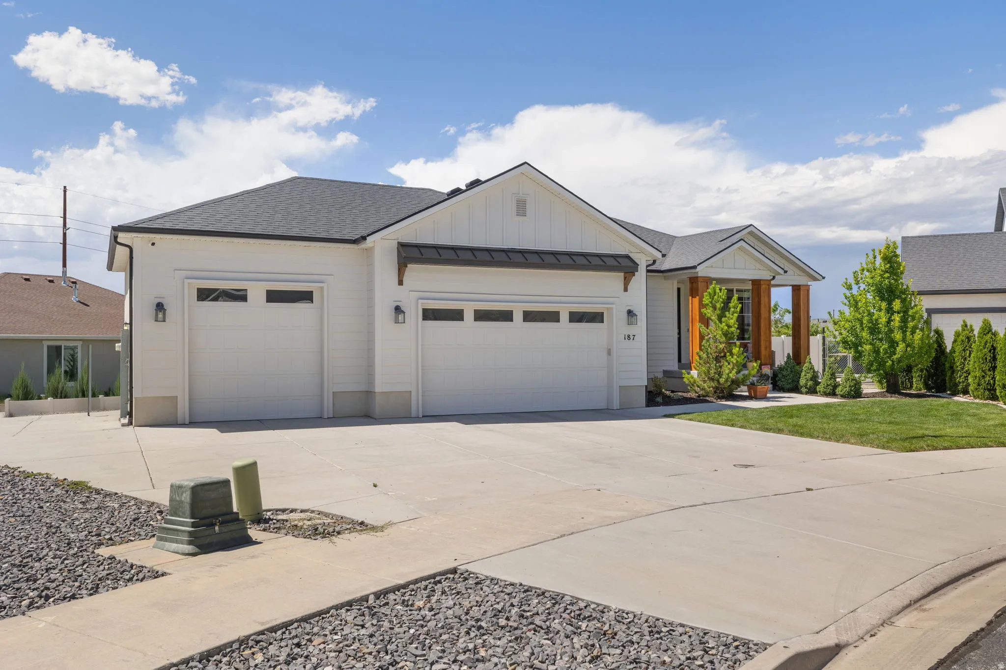 Contemporary exterior with white vertical siding and a dark shingled roof