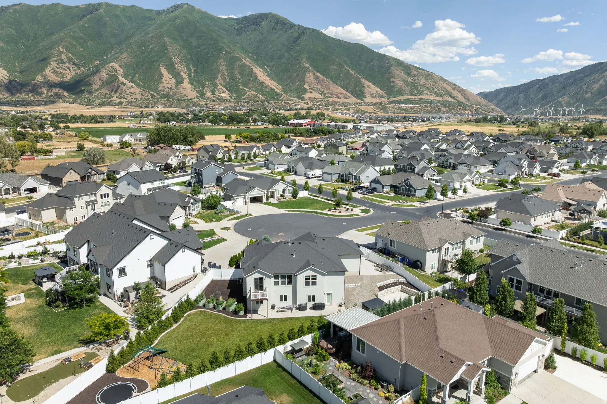 Aerial perspective showcasing a residential development with a mountain backdrop