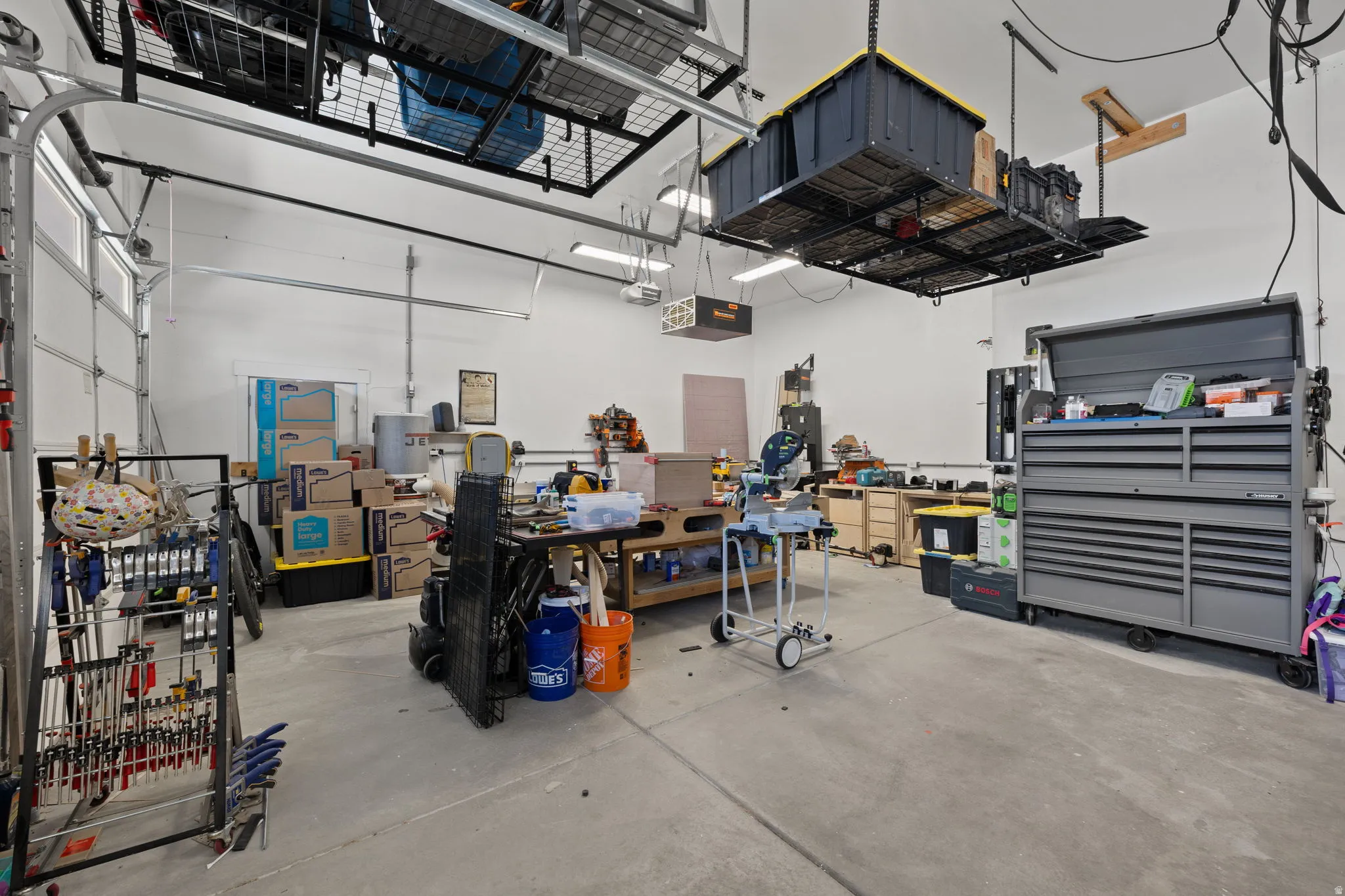 Spacious garage featuring concrete flooring and white walls