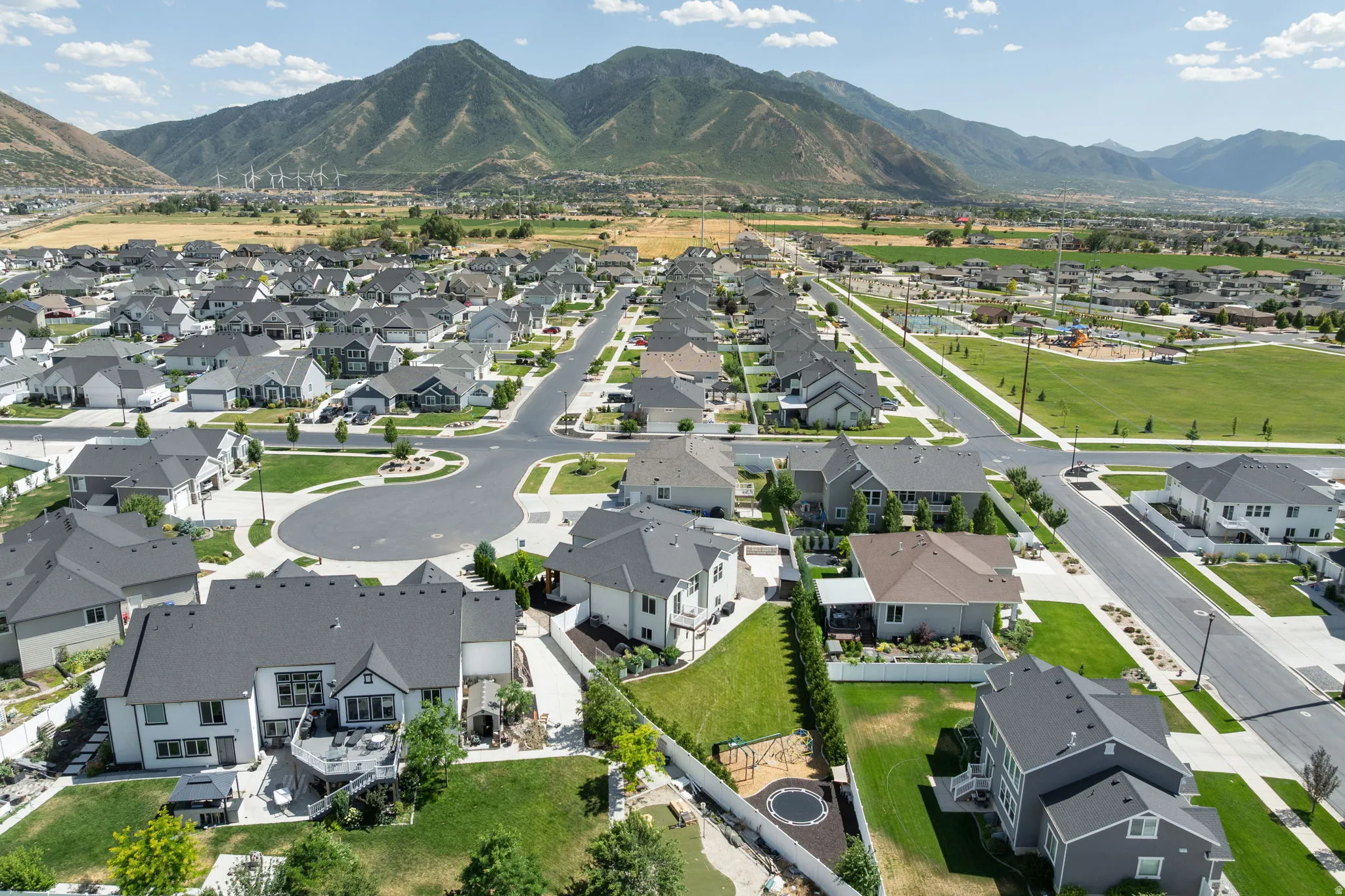 Aerial perspective showcasing a modern residential neighborhood with mountains in the background