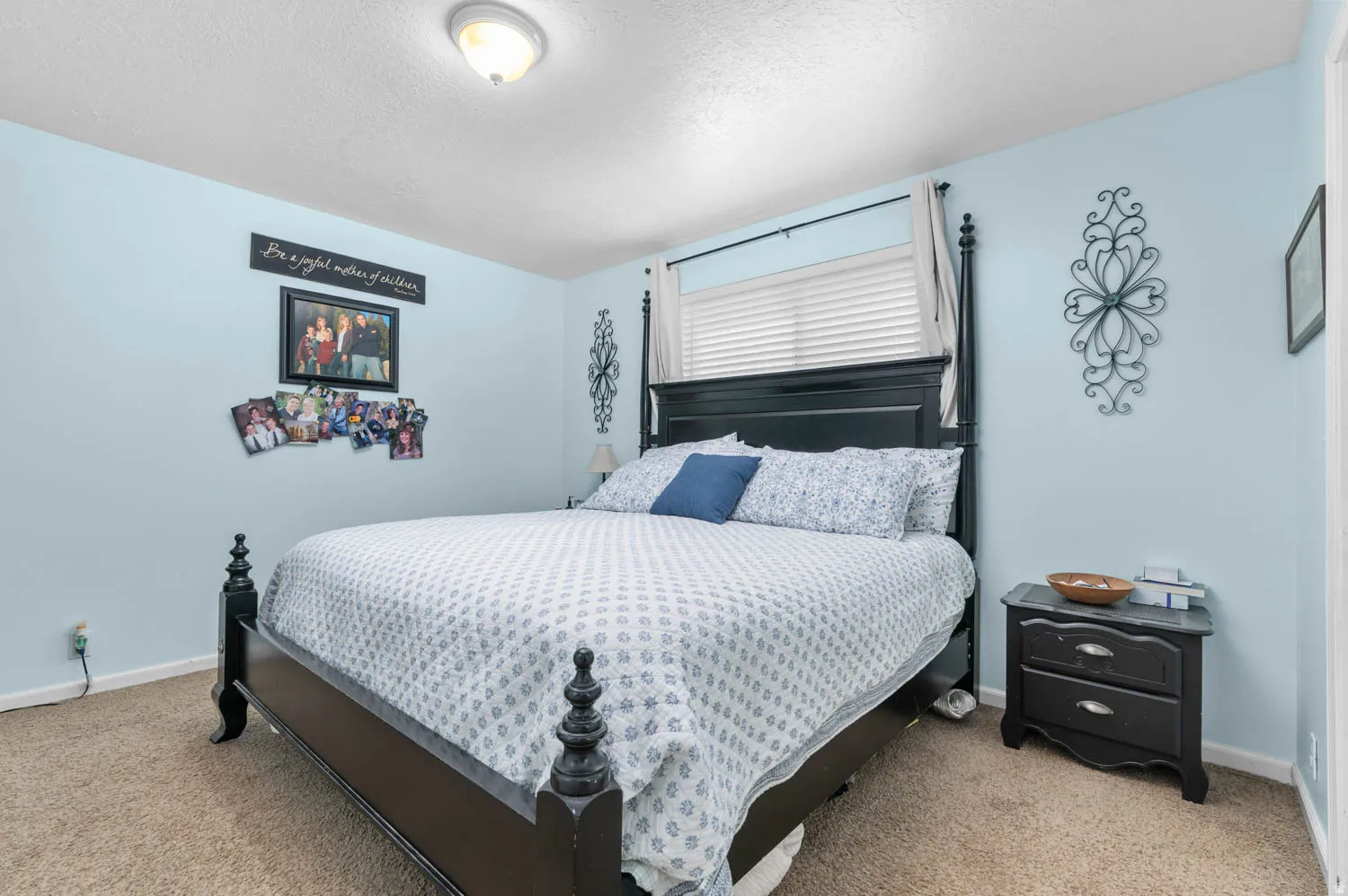 Carpeted bedroom with light blue walls