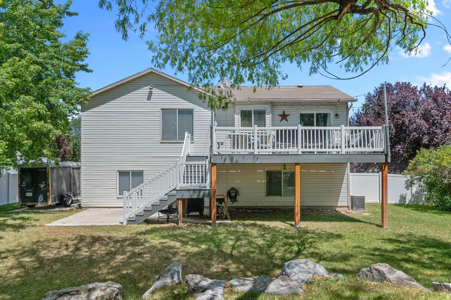 Rear exterior showcasing a two-story design with light-colored siding