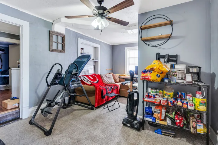Rental:  Room featuring textured walls, neutral carpet flooring, and a ceiling fan with integrated lighting
