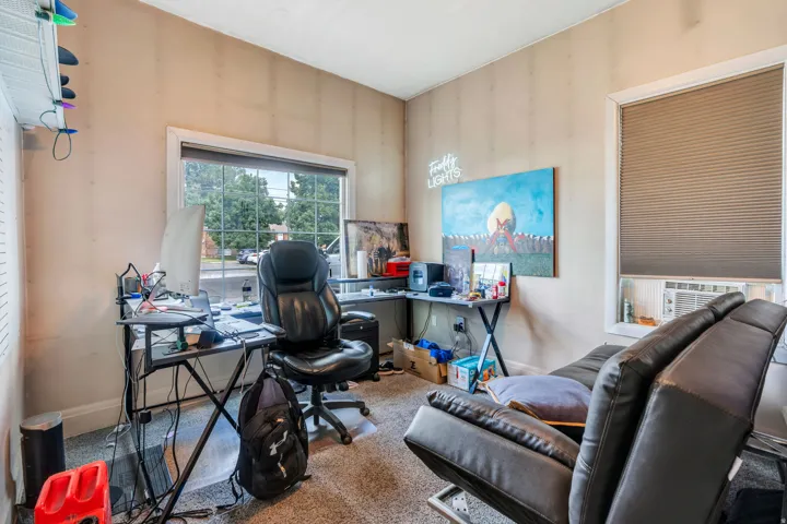Room featuring a window with a cellular shade, baseboard trim, and light-colored walls