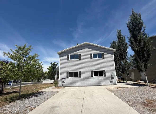 Two-story residence featuring gray siding and black window shutters