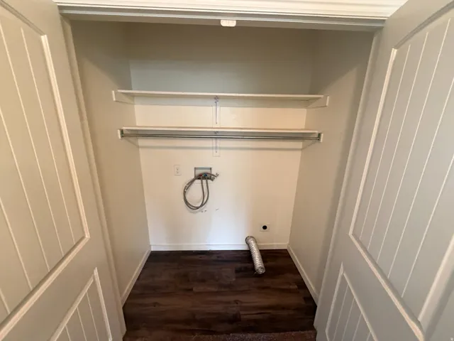 Laundry closet with wood-finish flooring