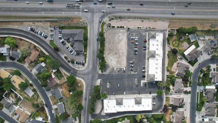 Aerial overview showcasing commercial properties, residential areas, and a highway