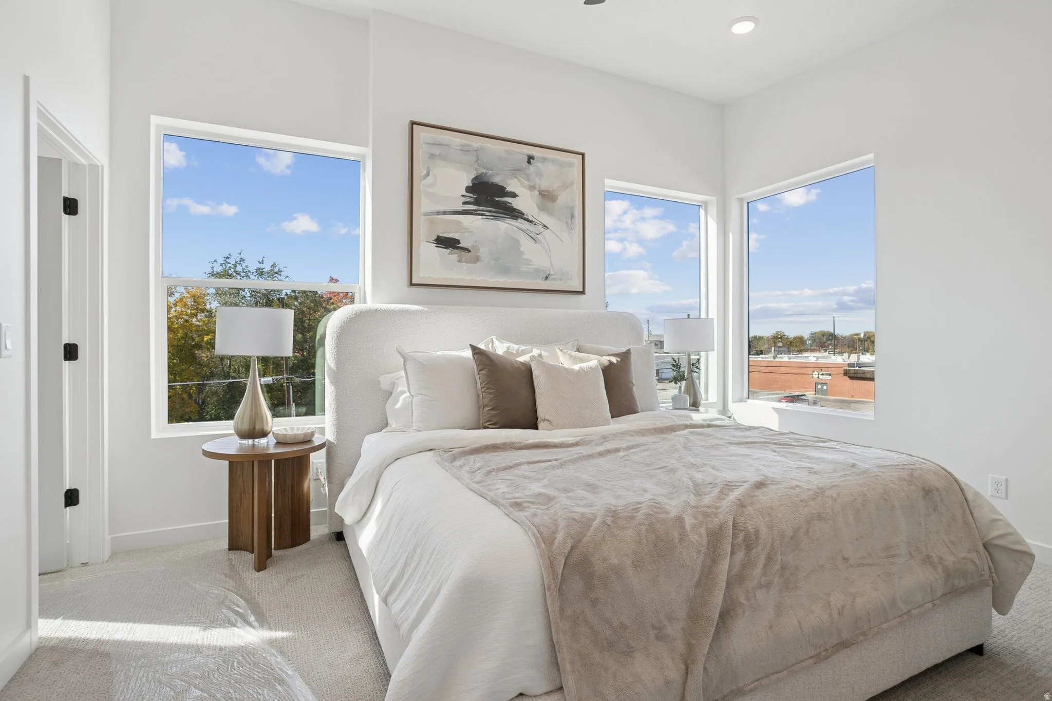 Bedroom featuring multiple large windows, recessed lighting, and light-colored carpeting