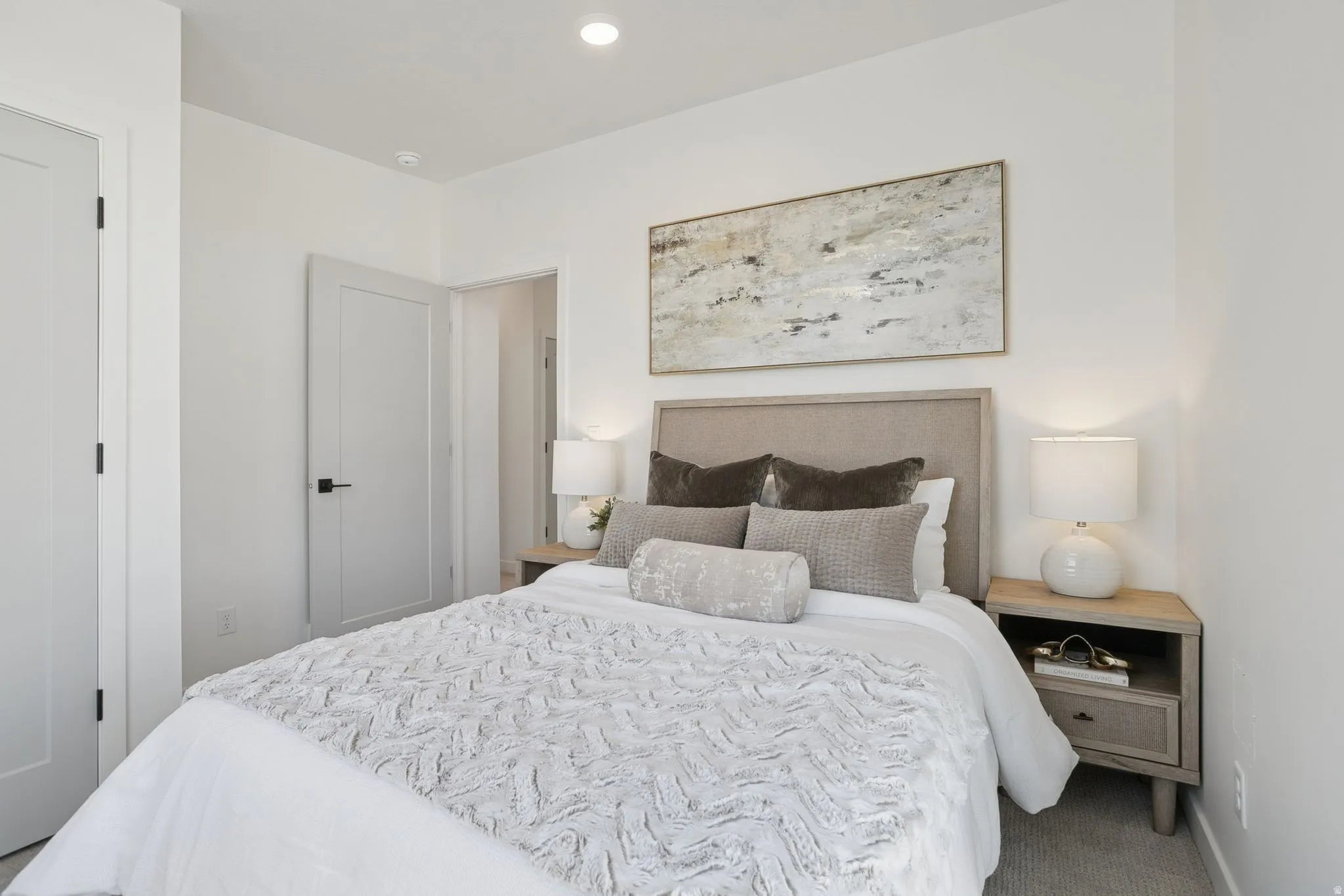 Bedroom featuring recessed lighting, a neutral color palette, and modern interior doors with dark hardware