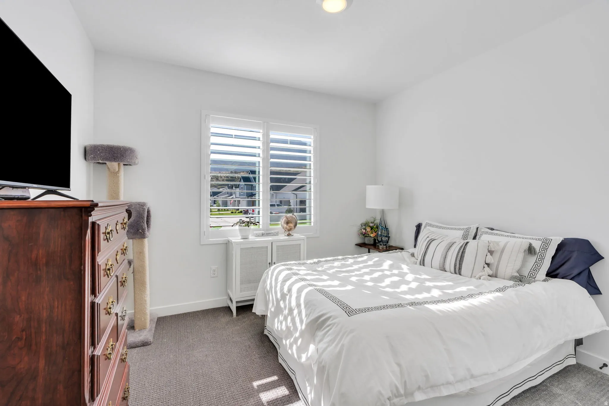 #1 Bedroom=Bright room featuring a window with plantation shutters, recessed lighting, and carpet flooring
