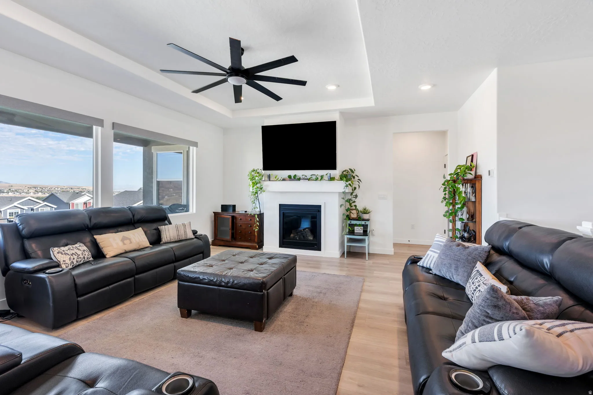 Living room with tray ceiling, Fireplace, incredible Views, and Power Shades