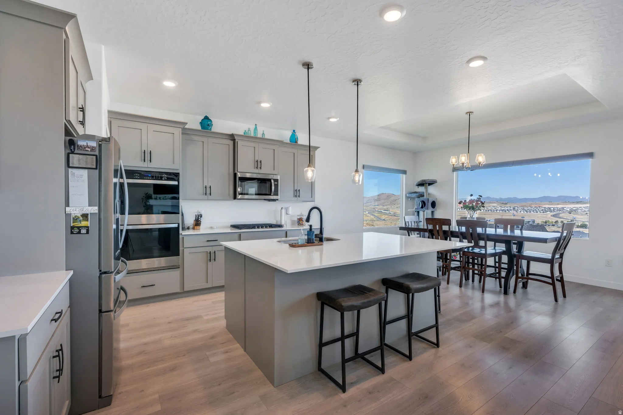 Open-concept kitchen and dining area featuring light wood-finish flooring, and VIEWS
